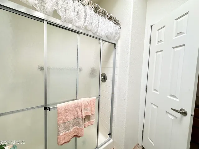 a bathroom with a shower and a shower