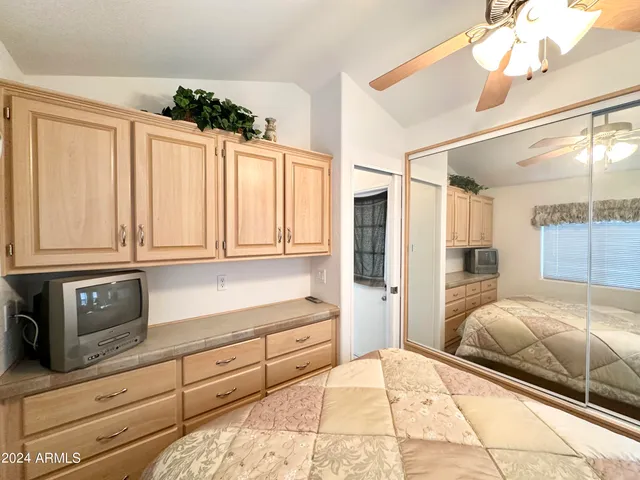 a bedroom with a bed and cabinets