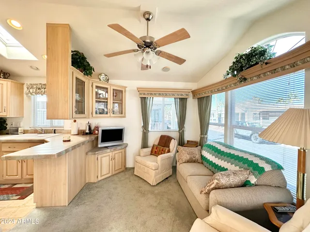 a living room with furniture a fireplace and a chandelier