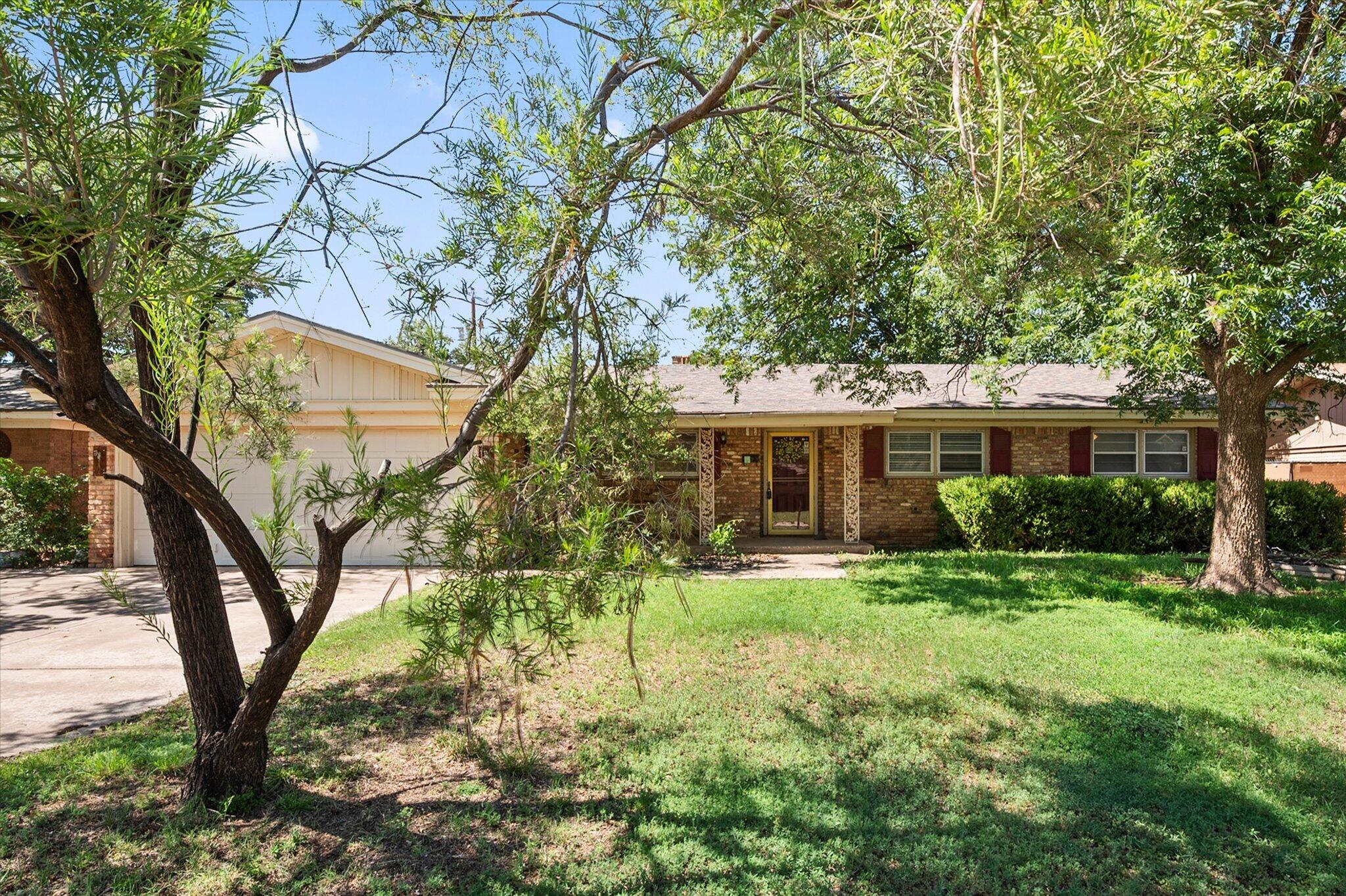 4604 27th Street Lubbock, TX 79410 - Photo 2 of 36 a front view of a house with a yard