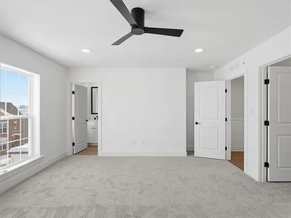 a bathroom with a shower sink vanity mirror and toilet