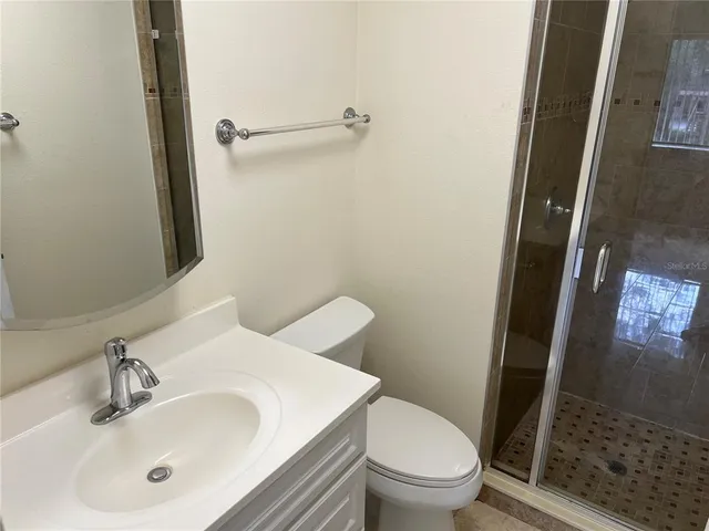 a white toilet sitting next to a bath tub