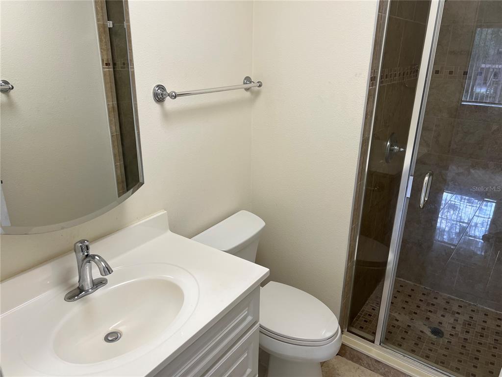 510 Mistletoe Court, Unit D Safety Harbor, FL 34695 - Photo 11 of 18 a bathroom with a sink and a mirror