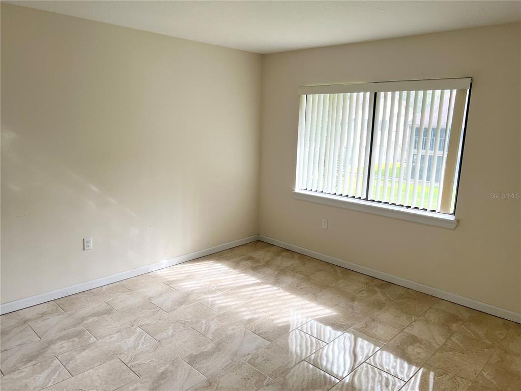 510 Mistletoe Court, Unit D Safety Harbor, FL 34695 - Photo 10 of 18 an empty room with a window