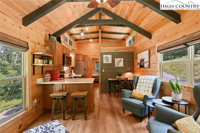 a living room with furniture and a floor to ceiling window