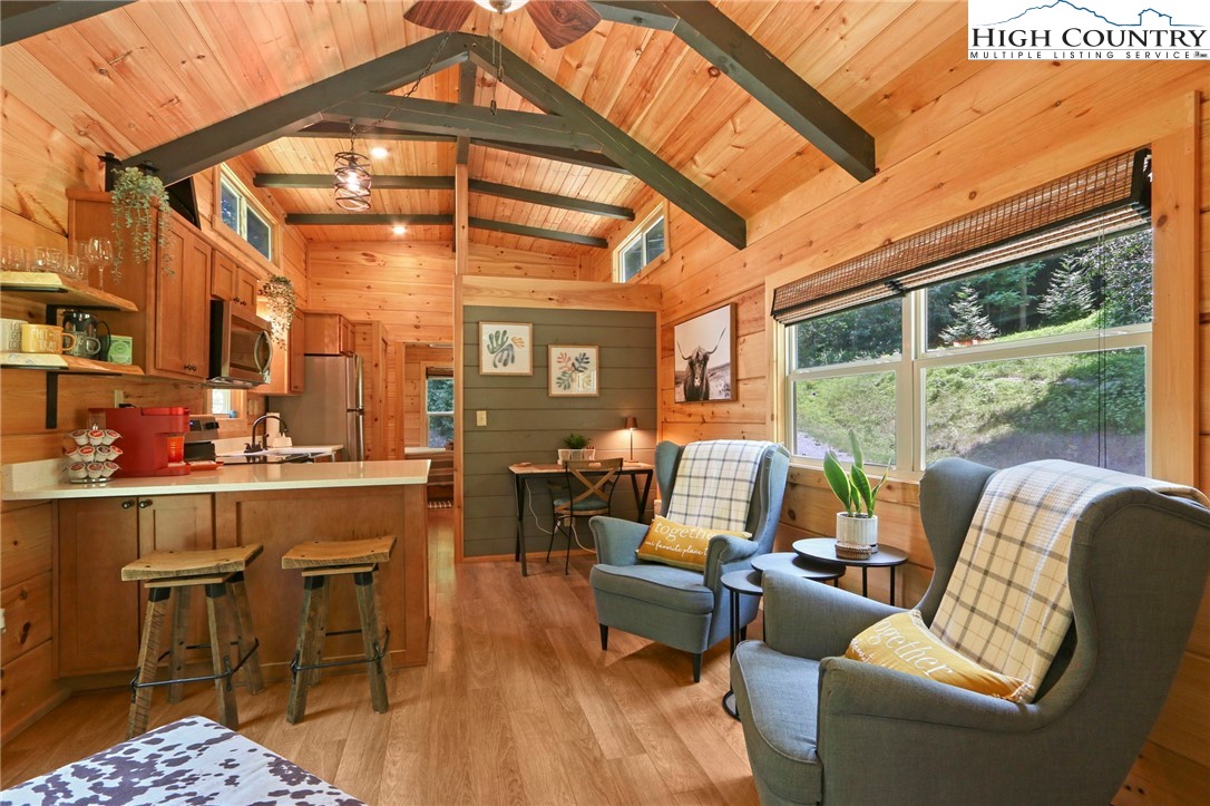 165 John Dotson Road Boone, NC 28607 - Photo 21 of 50 a living room with furniture a rug and a large window