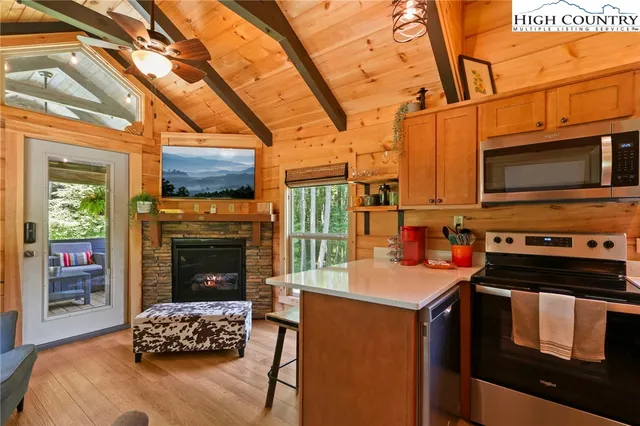 a kitchen with stainless steel appliances kitchen island granite countertop a sink and cabinets