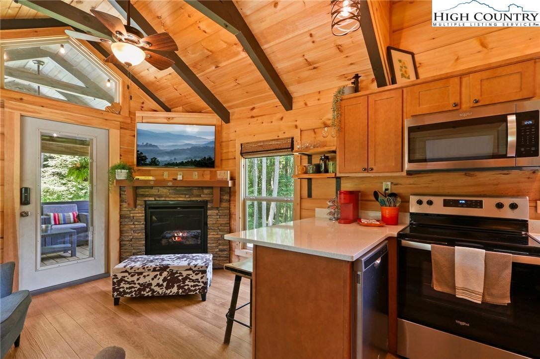 165 John Dotson Road Boone, NC 28607 - Photo 23 of 50 a kitchen with a stove a sink and a microwave