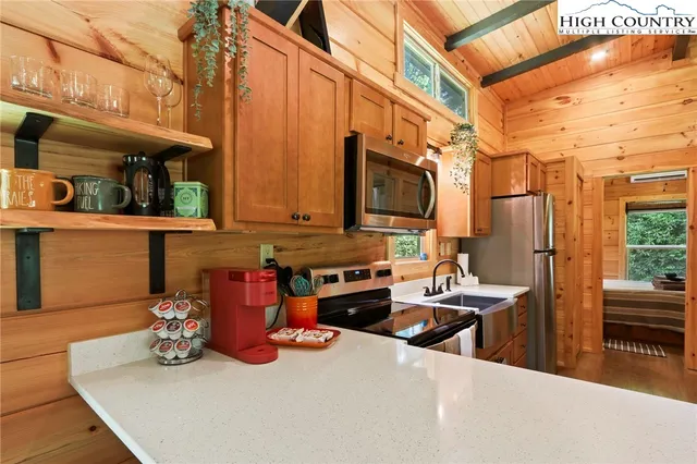 a kitchen with stainless steel appliances a stove a microwave and a refrigerator