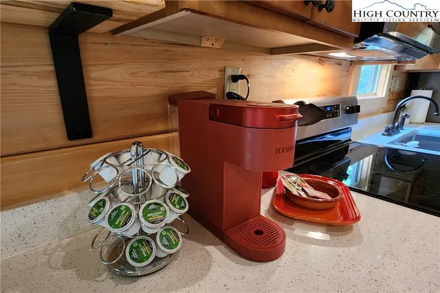 a living room with furniture a fireplace and wooden floor