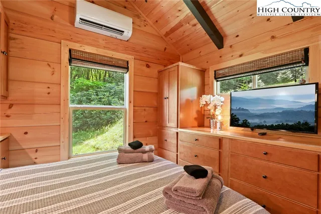 a bedroom with a bed and a mirror