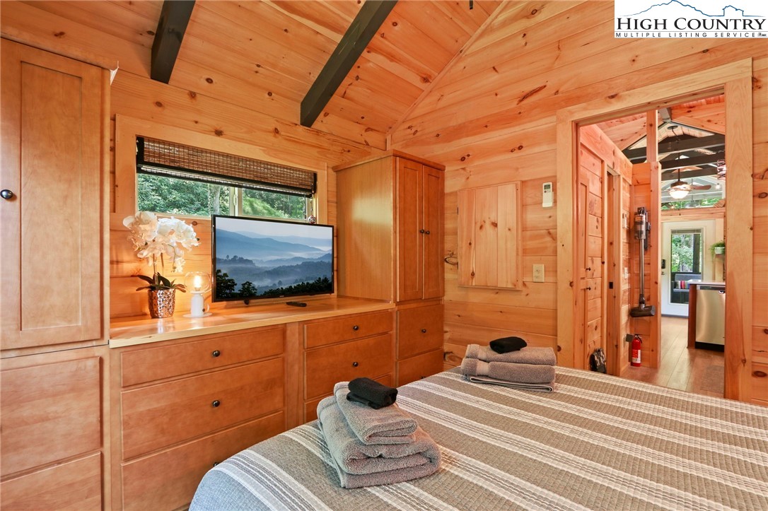 165 John Dotson Road Boone, NC 28607 - Photo 36 of 50 a bedroom with a bed and a flat screen tv