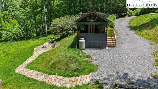 a view of a house with a yard and wooden deck