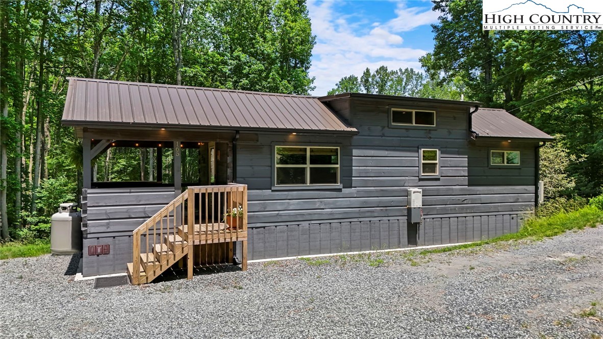 165 John Dotson Road Boone, NC 28607 - Photo 42 of 50 a view of a house with a yard and wooden deck