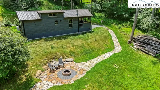 an aerial view of a house with a yard