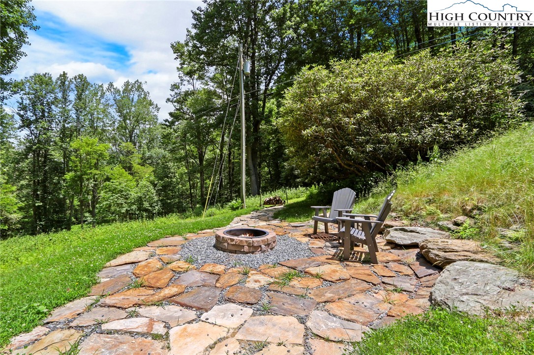 165 John Dotson Road Boone, NC 28607 - Photo 45 of 50 a view of a chair and table on the garden