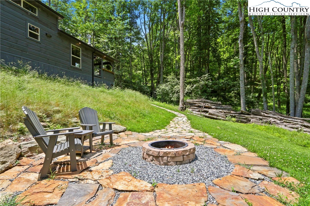 165 John Dotson Road Boone, NC 28607 - Photo 7 of 50 a view of a backyard with table and chairs potted plants and large tree