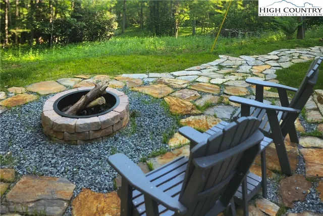 a view of a backyard with sitting area and outdoor kitchen
