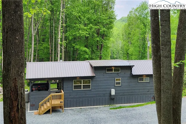 a backyard of a house with table and chairs