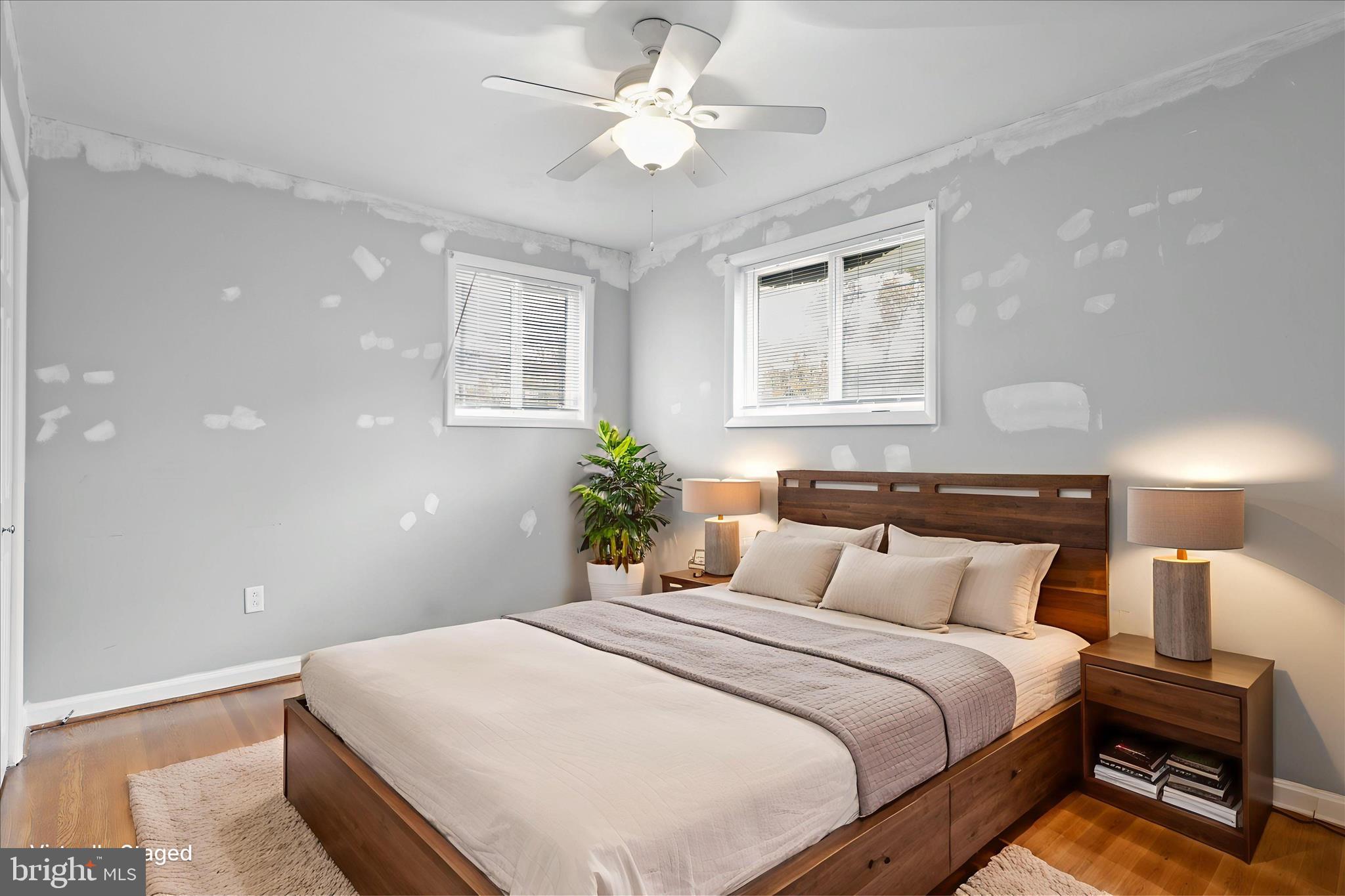 112 Main Avenue Southeast Glen Burnie, MD 21061 - Photo 14 of 45 a bedroom with a large bed and a chandelier