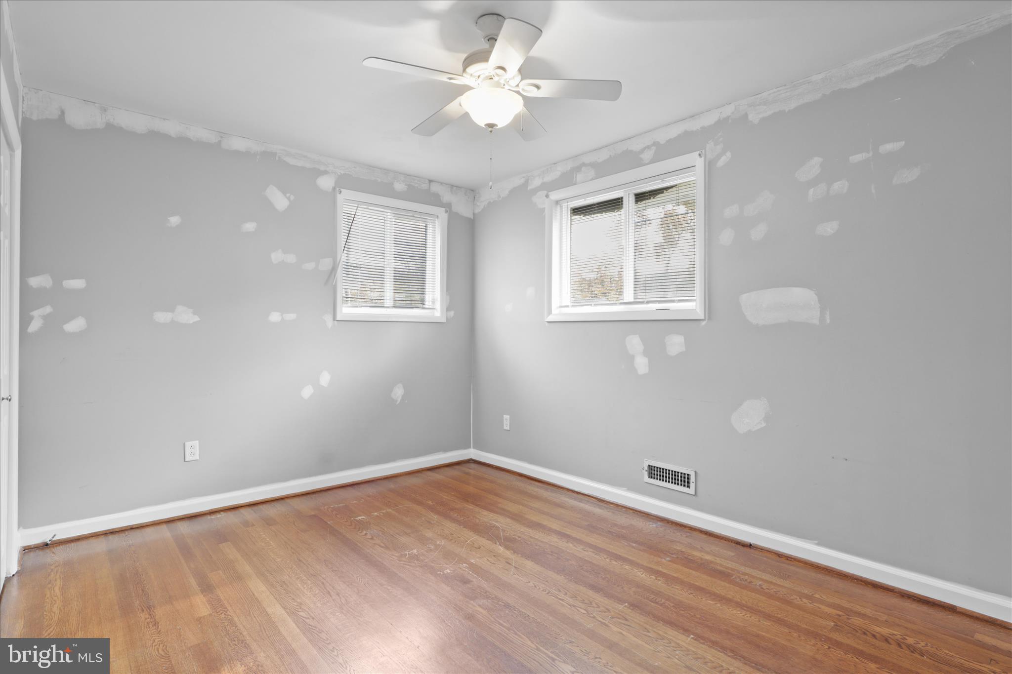 112 Main Avenue Southeast Glen Burnie, MD 21061 - Photo 15 of 45 a view of an empty room with wooden floor and a window