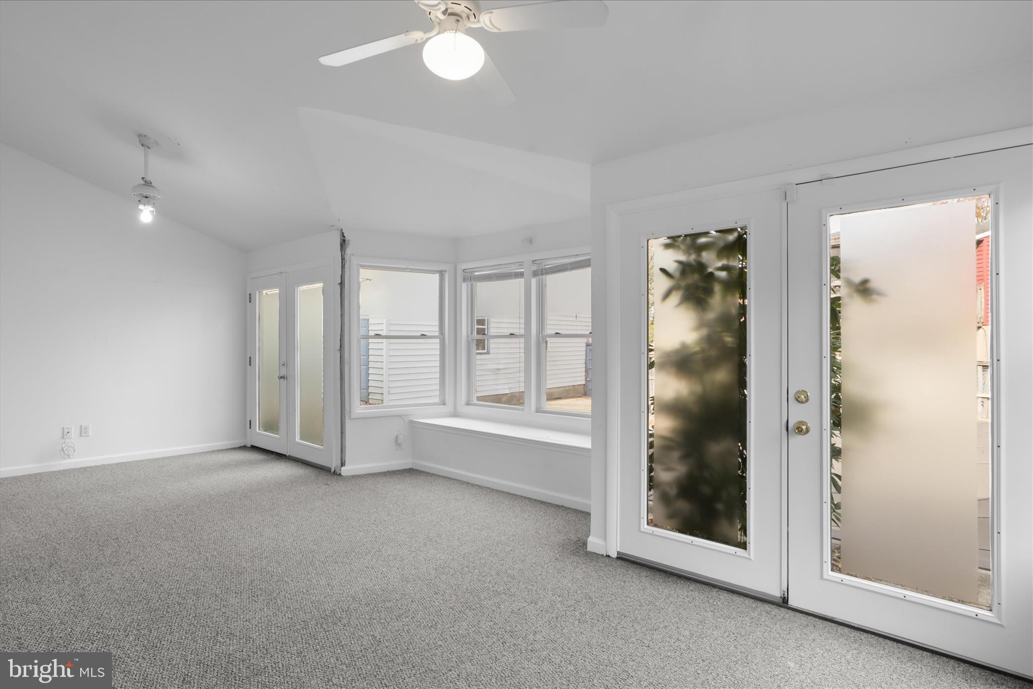112 Main Avenue Southeast Glen Burnie, MD 21061 - Photo 23 of 45 a view of an empty room with a glass door and a bathroom