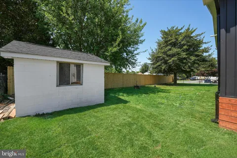 a view of a backyard with large trees