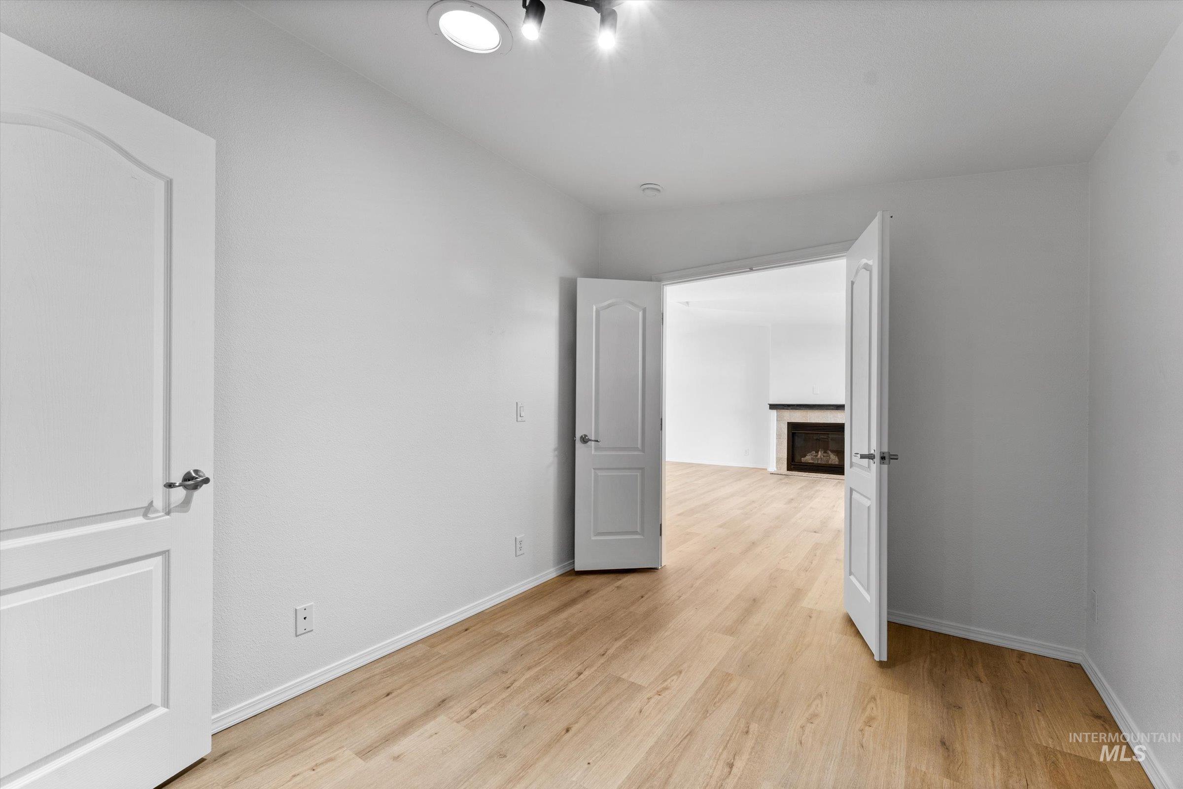421 South Curtis Road, Unit 122 122 Boise, ID 83705 - Photo 11 of 24 Spare room featuring a fireplace and light wood-style floors