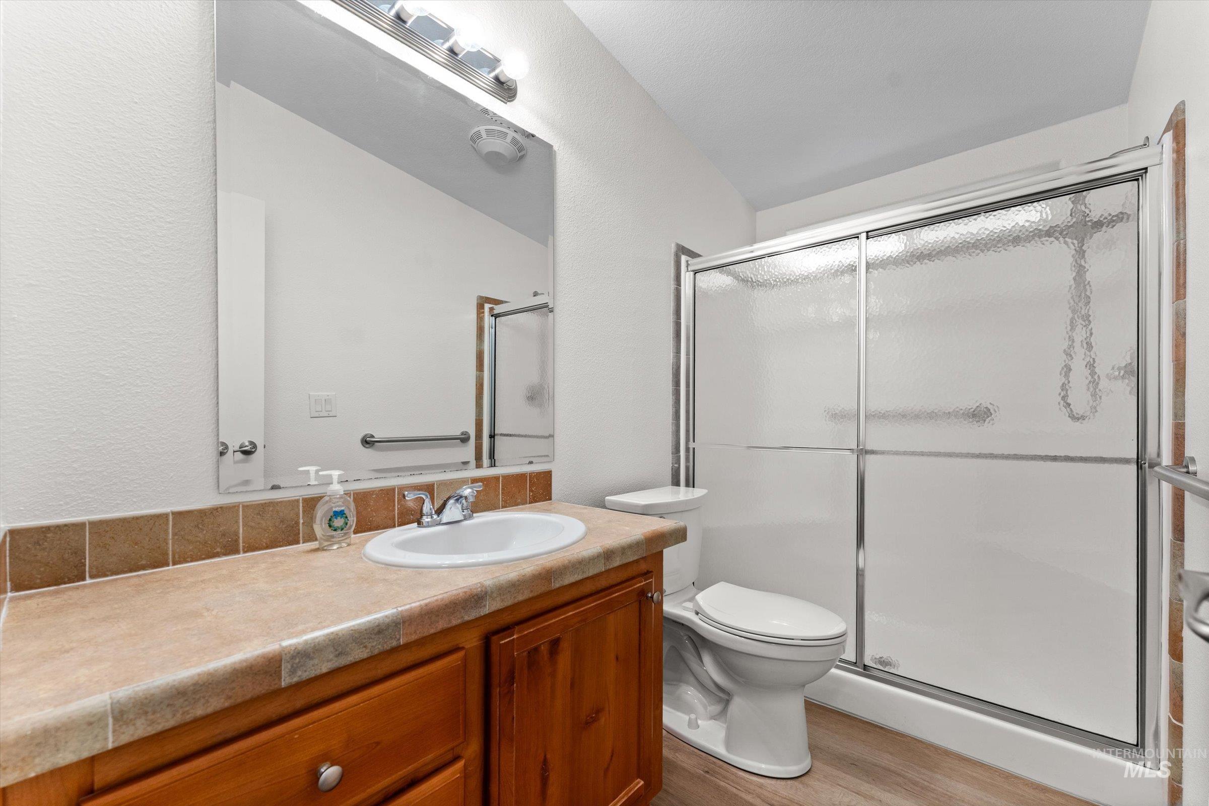 421 South Curtis Road, Unit 122 122 Boise, ID 83705 - Photo 15 of 24 Bathroom featuring vanity, a shower stall, and light wood finished floors
