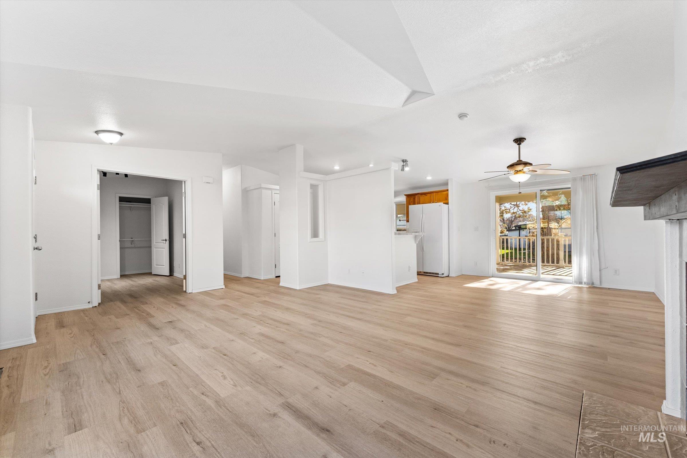421 South Curtis Road, Unit 122 122 Boise, ID 83705 - Photo 3 of 24 Unfurnished living room featuring light wood-style flooring and a ceiling fan