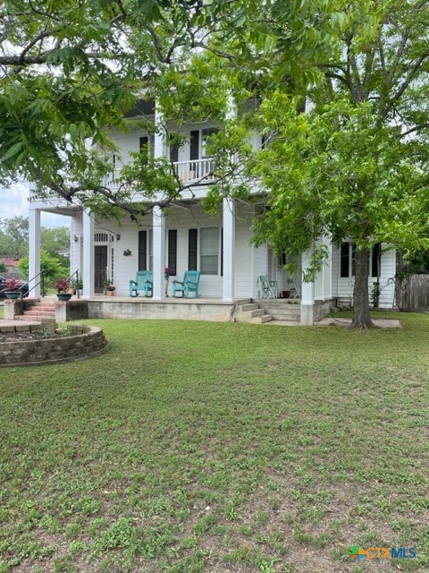 508 East Courthouse Street Cuero, TX 77954 - Photo 1 of 10 a front view of a house with garden