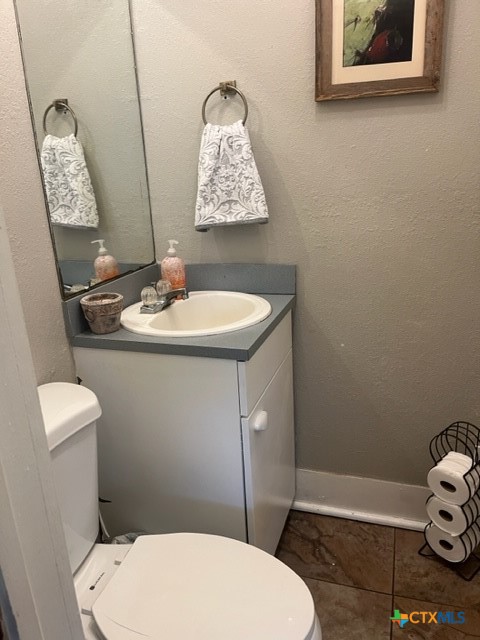508 East Courthouse Street Cuero, TX 77954 - Photo 8 of 10 a bathroom with a toilet sink and mirror