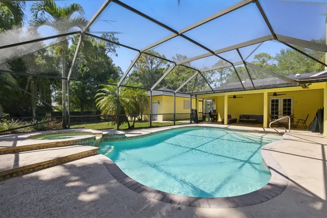 a view of a house with backyard and porch