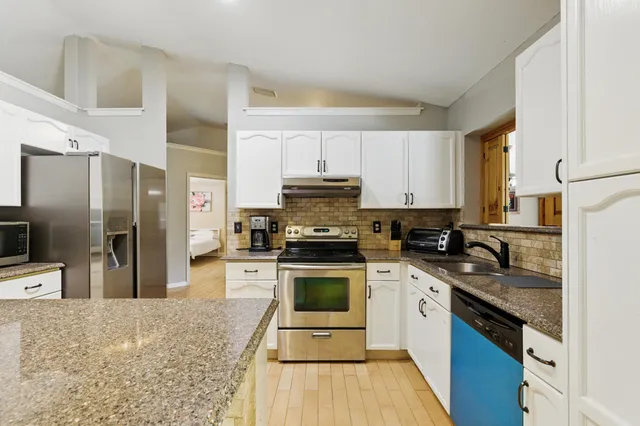 a kitchen with a sink stove and refrigerator