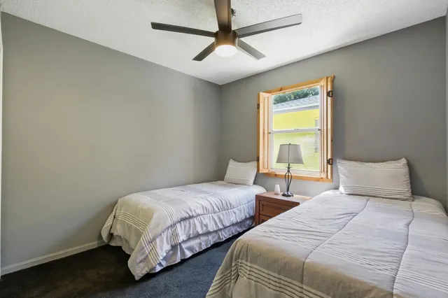 a bedroom with two beds and a window