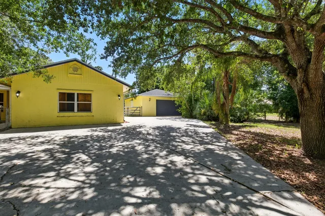 a view of a house with a tree