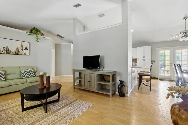 a living room with furniture and a flat screen tv
