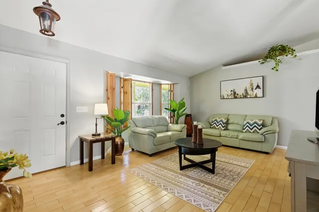 a living room with furniture and wooden floor