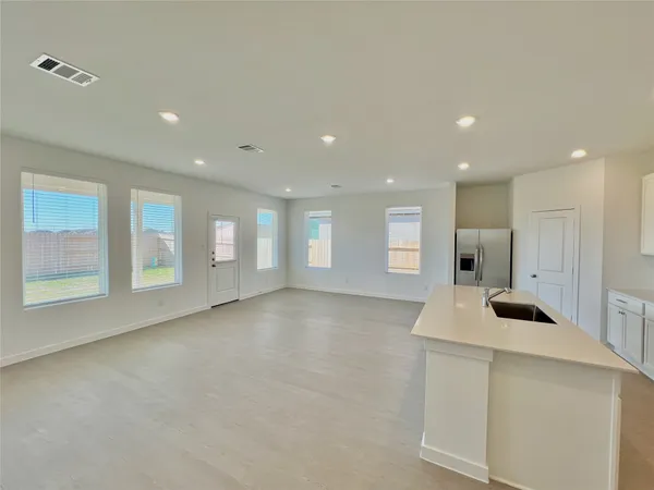a spacious bathroom with a double vanity sink and a mirror