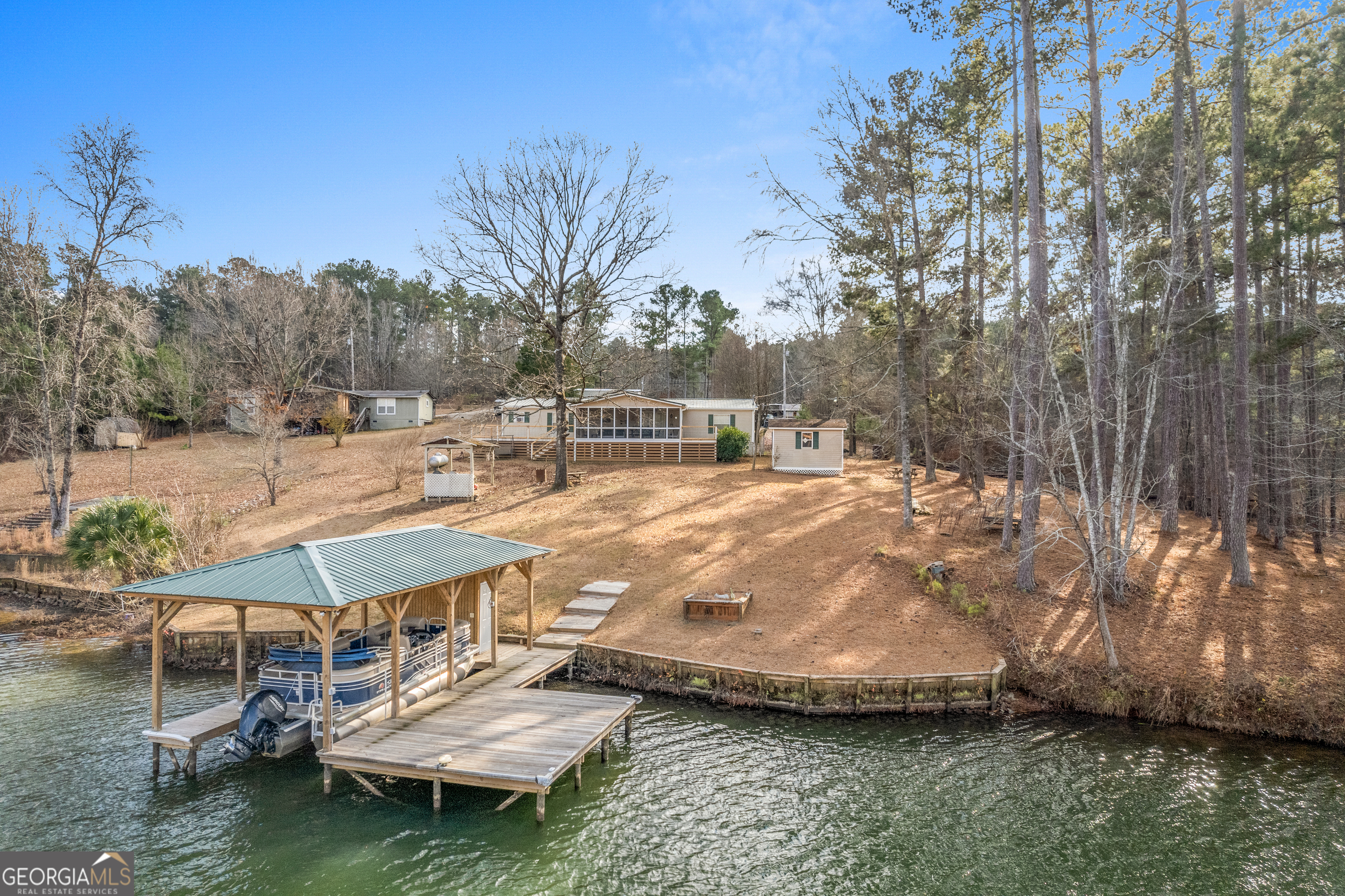 Newly constructed dock with single stall boathouse with storage closet.