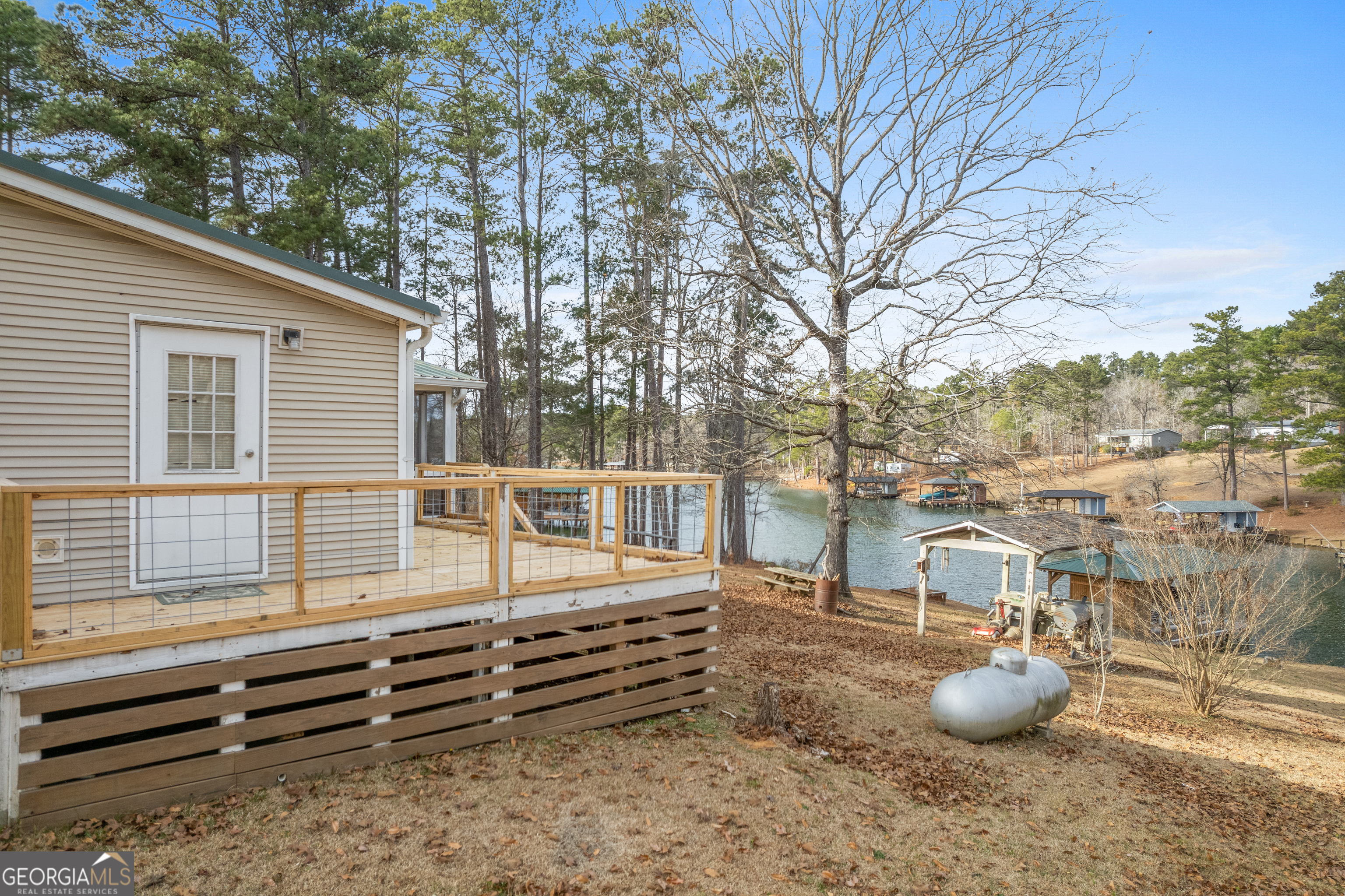 184 Brandywine Run Sparta, GA 31087 - Photo 23 of 72 a backyard of a house with barbeque oven and large trees