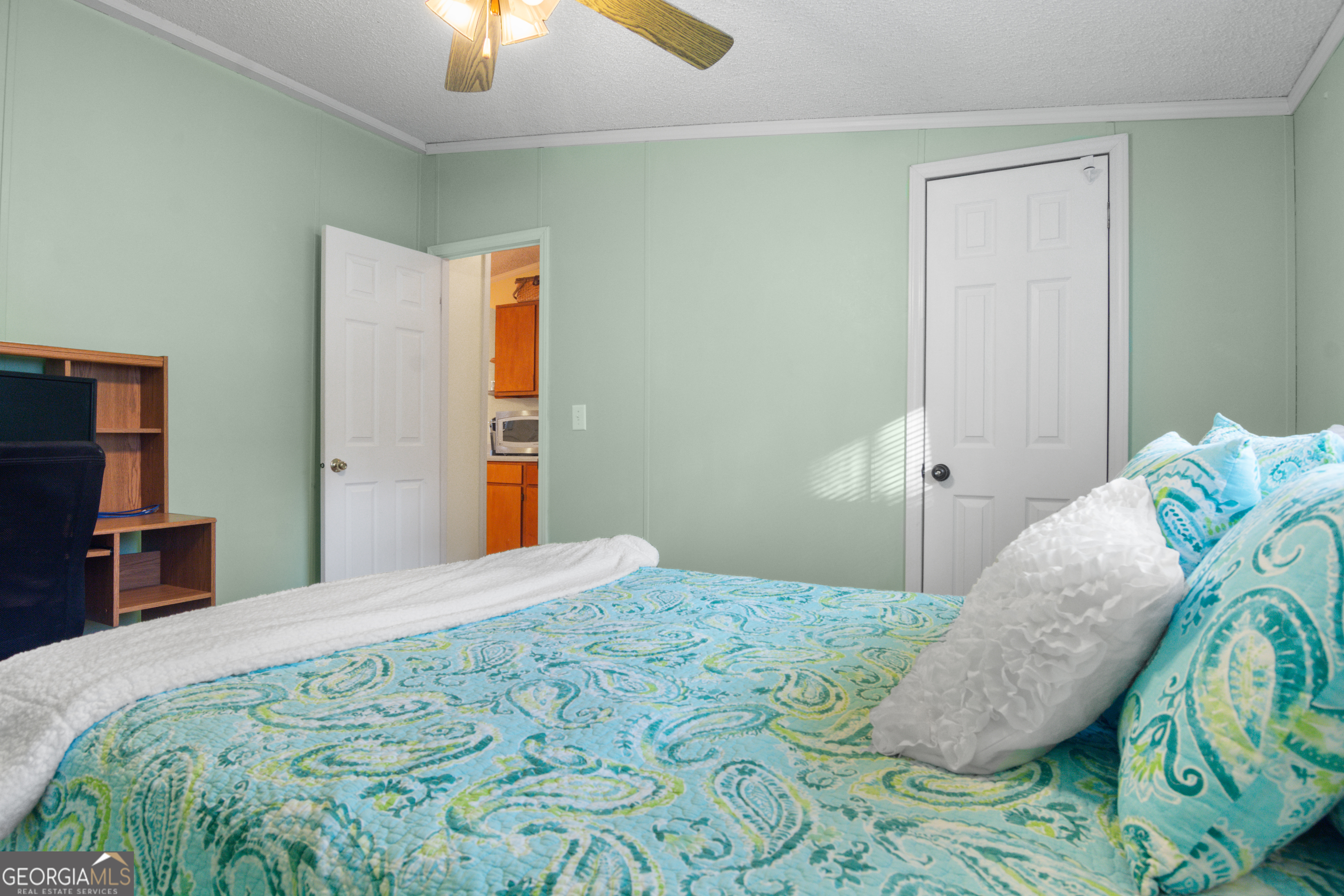 184 Brandywine Run Sparta, GA 31087 - Photo 59 of 72 a bedroom with a bed and a chandelier