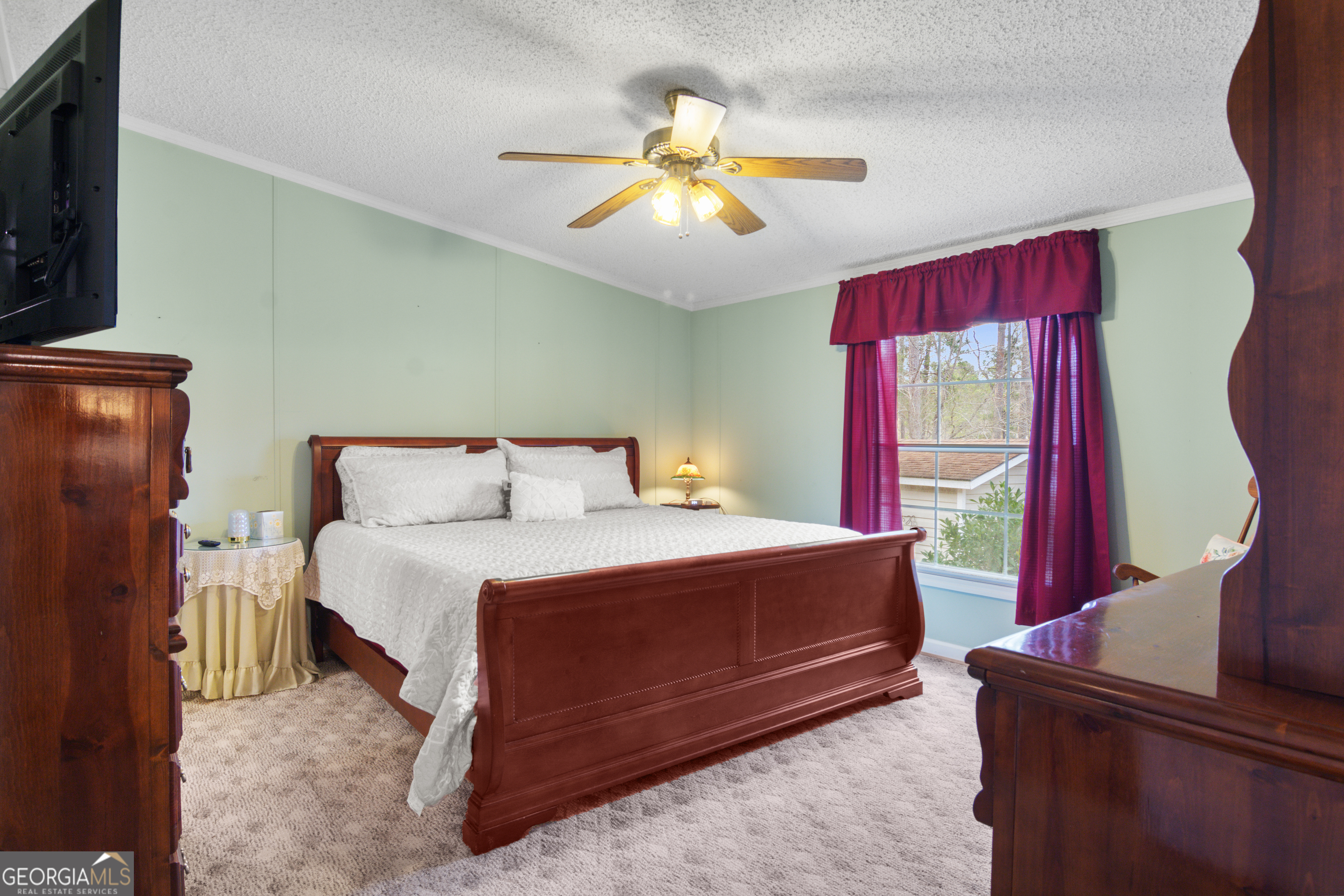 184 Brandywine Run Sparta, GA 31087 - Photo 61 of 72 a bedroom with a bed and a chandelier