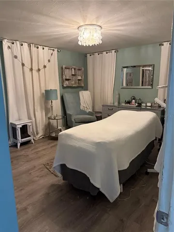 a bed sitting in a spacious bedroom next to a window