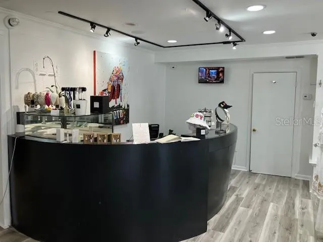 a room with lots of counter space and wooden floor