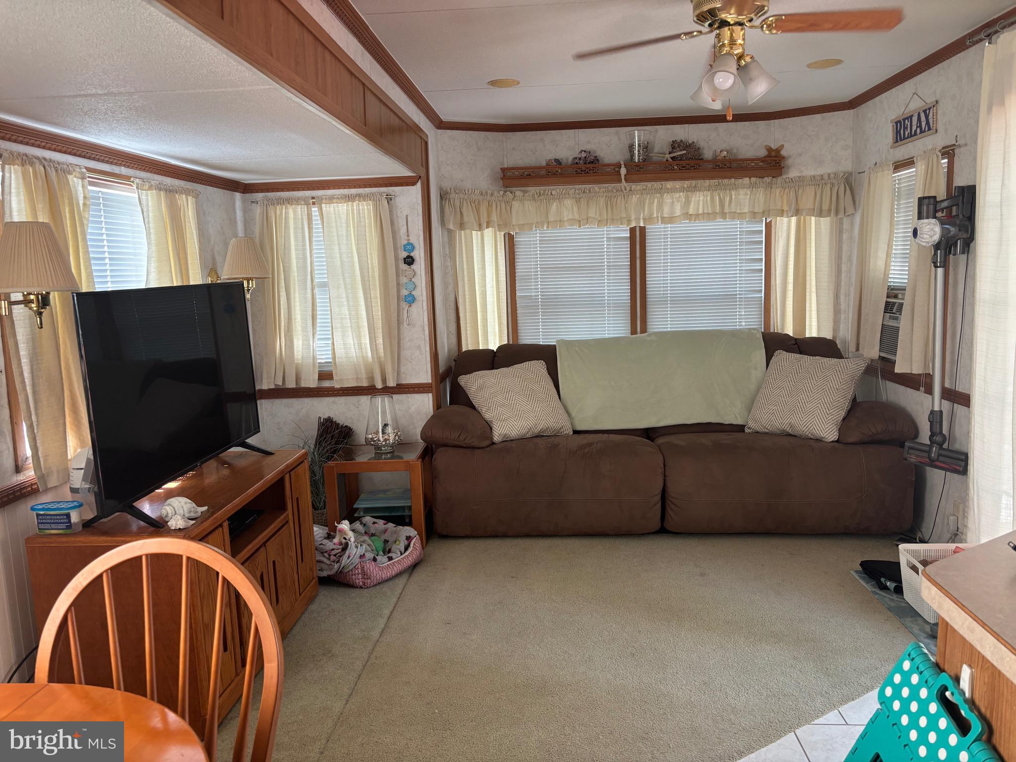 60 Corsons Tavern Road, Unit 248 Ocean View, NJ 08230 - Photo 12 of 18 a living room with furniture and a flat screen tv