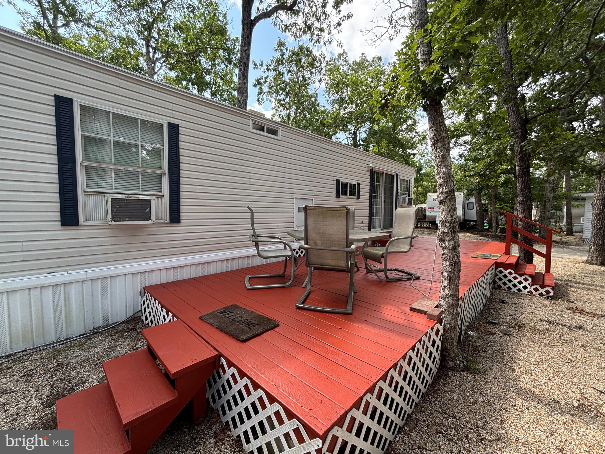 60 Corsons Tavern Road, Unit 248 Ocean View, NJ 08230 - Photo 3 of 18 a view of a patio with table and chairs and wooden fence