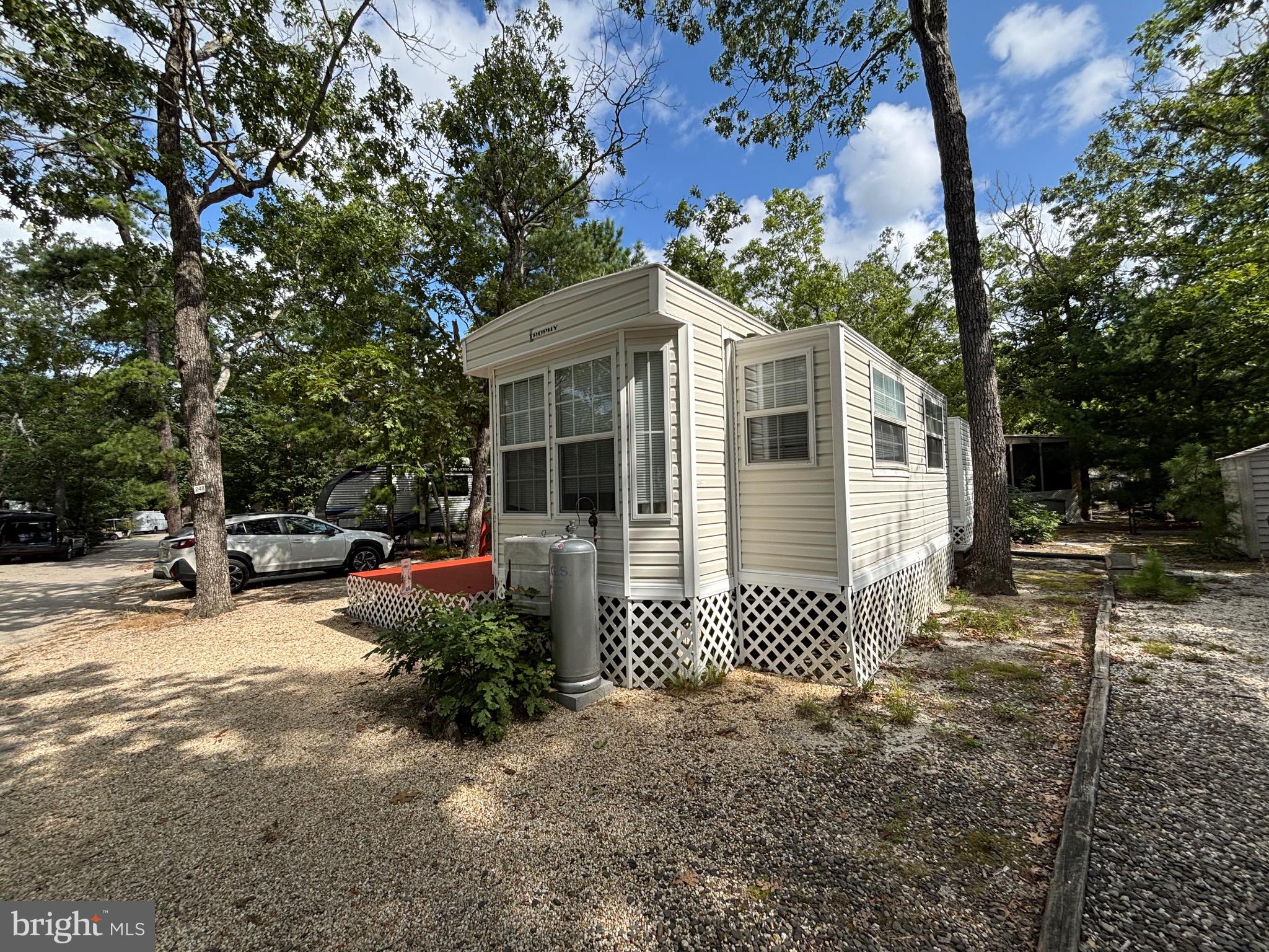 60 Corsons Tavern Road, Unit 248 Ocean View, NJ 08230 - Photo 5 of 18 a front view of a house with a garden