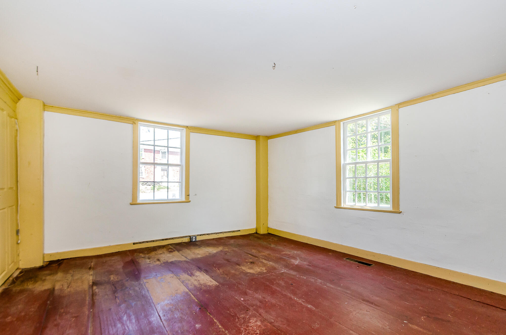 4701 Falmouth Road Cotuit, MA 02635 - Photo 18 of 39 a view of an empty room with wooden floor and a window