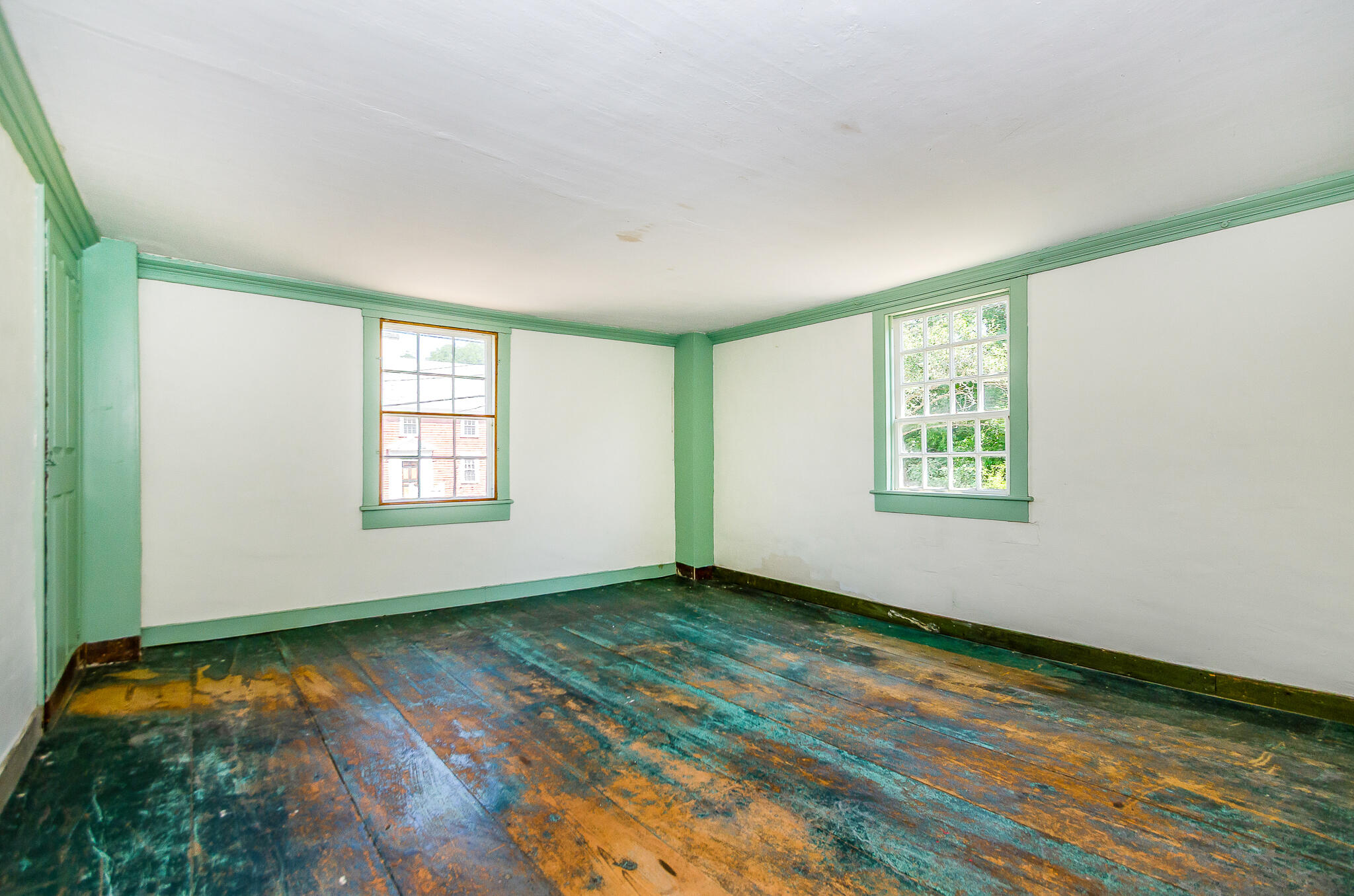 4701 Falmouth Road Cotuit, MA 02635 - Photo 20 of 39 an empty room with wooden floor and windows